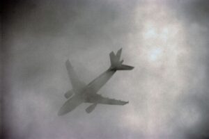 An airplane flies through spooky clouds