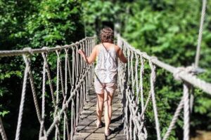 A rope bridge spans the crystal clear water of the Siban River on the 50,000 acre Sleeping Giant Rainforest Lodge property, a National Geographic base camp